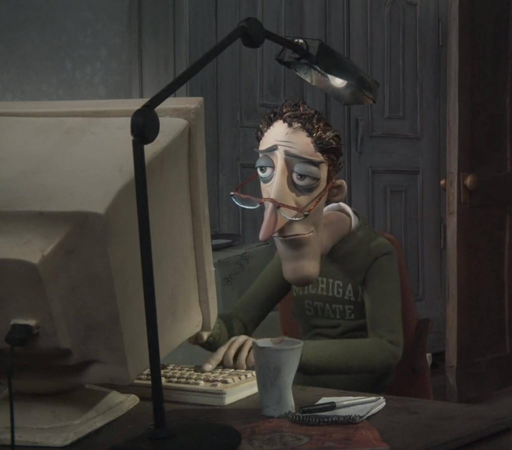 Padre escribiendo en el ordenador apenado y somnoliento en la película Coraline.